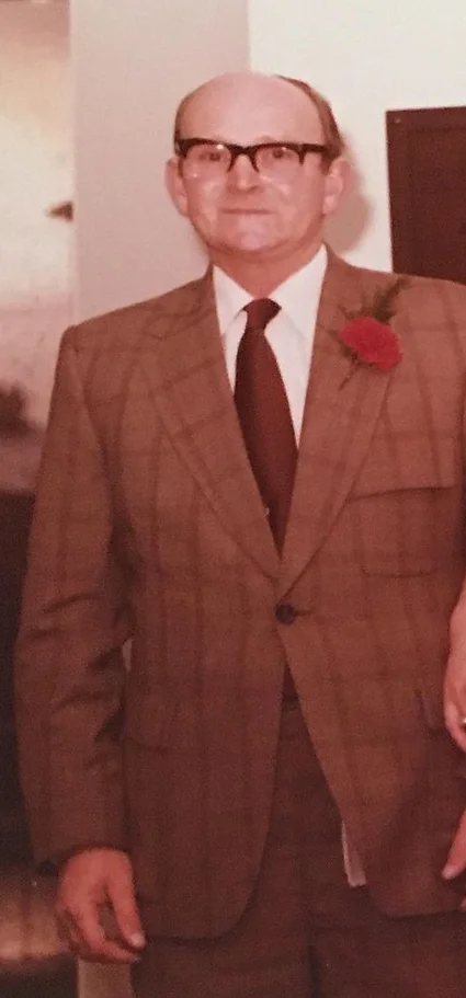 Chalres younger in brown suit